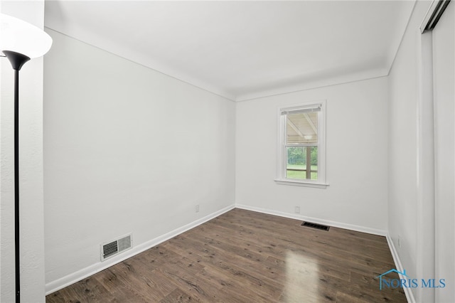 1247 Hugo St, Maumee, OH 43537 - unfurnished room with baseboards and dark wood-style floors