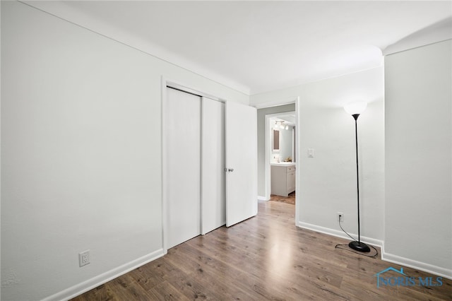 1247 Hugo St, Maumee, OH 43537 - unfurnished bedroom featuring wood finished floors and a closet