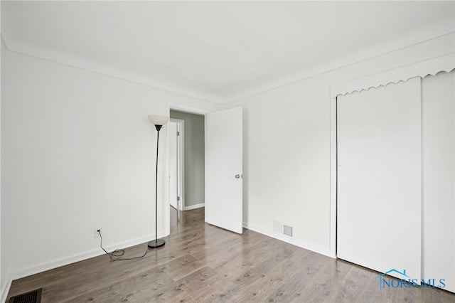 1247 Hugo St, Maumee, OH 43537 - unfurnished bedroom featuring wood finished floors and baseboards