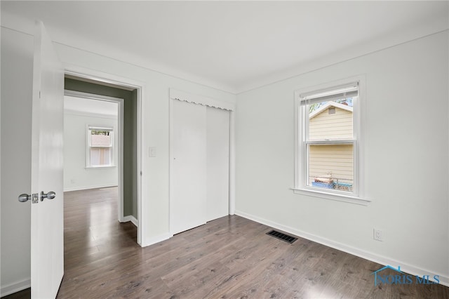1247 Hugo St, Maumee, OH 43537 - unfurnished bedroom featuring dark wood finished floors and a closet