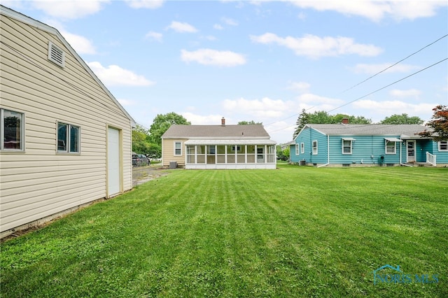 1247 Hugo St, Maumee, OH 43537 - view of grassy yard featuring a sunroom