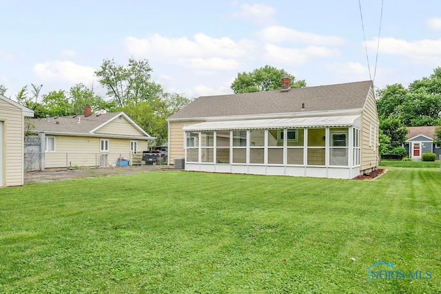 1247 Hugo St, Maumee, OH 43537 - rear view of house with a sunroom and roof with shingles