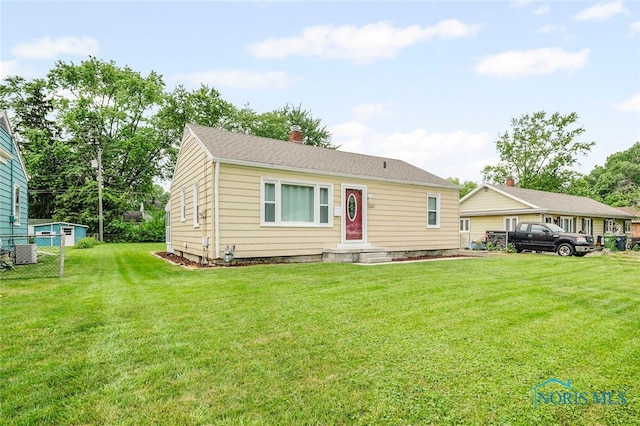 1247 Hugo St, Maumee, OH 43537 - view of front of home featuring a front lawn and a chimney