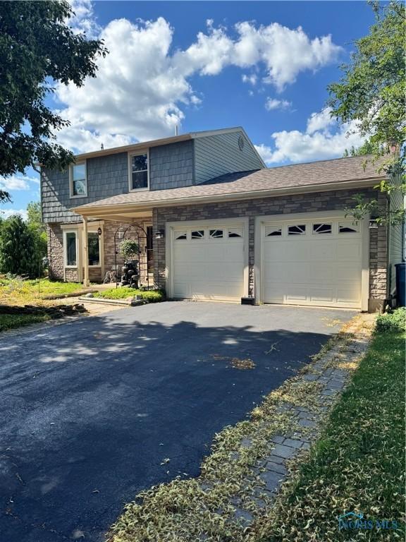 843 Colonial Ct, Waterville, OH 43566 - view of front of property with an attached garage and asphalt driveway