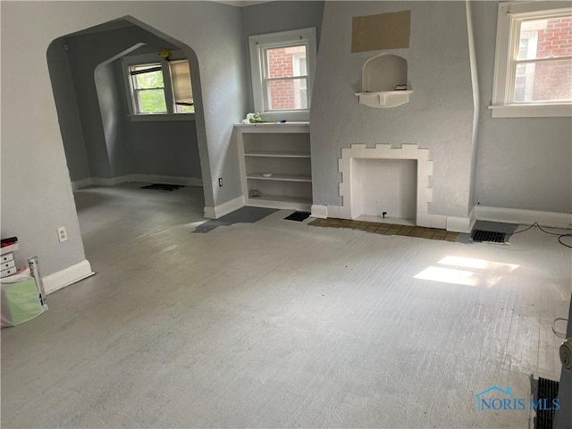 2615 Greenway St, Toledo, OH 43607 - unfurnished living room with arched walkways and carpet