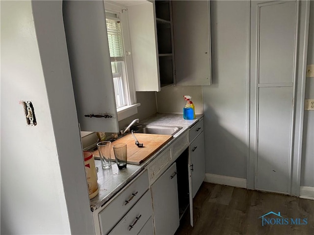 2615 Greenway St, Toledo, OH 43607 - kitchen featuring wood finished floors, open shelves, and white cabinets