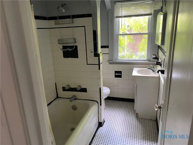 2615 Greenway St, Toledo, OH 43607 - full bathroom with vanity, tile patterned floors, shower / bathtub combination, and tile walls