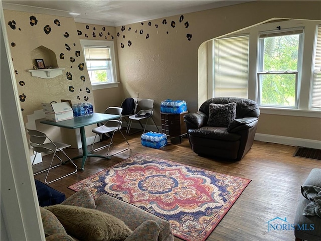2615 Greenway St, Toledo, OH 43607 - sitting room featuring wood finished floors, arched walkways, and a textured wall