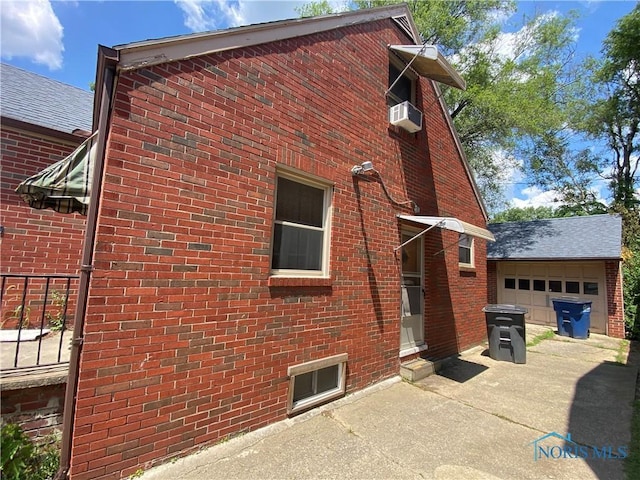 2534 Montebello Rd, Toledo, OH 43607 - view of side of property with brick siding, concrete driveway, and a garage