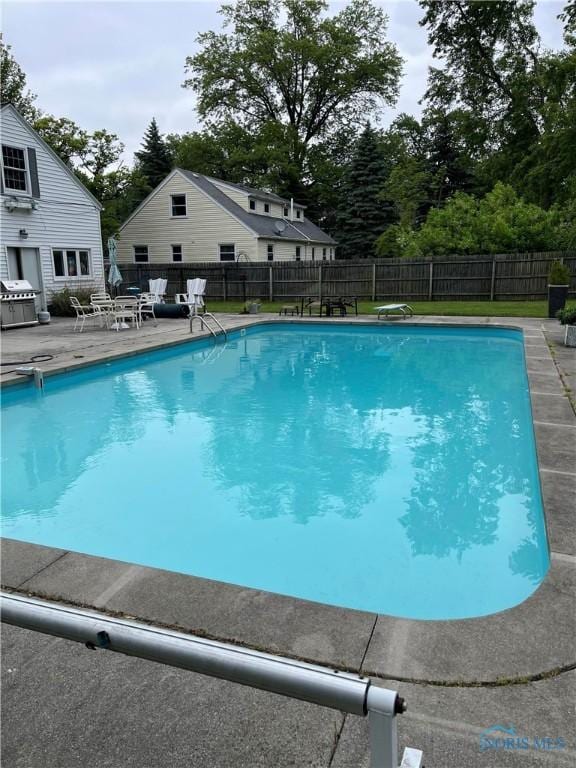 849 Wallace Ave, Bowling Green, OH 43402 - view of swimming pool with grilling area, a patio area, a fenced backyard, and view of scattered trees