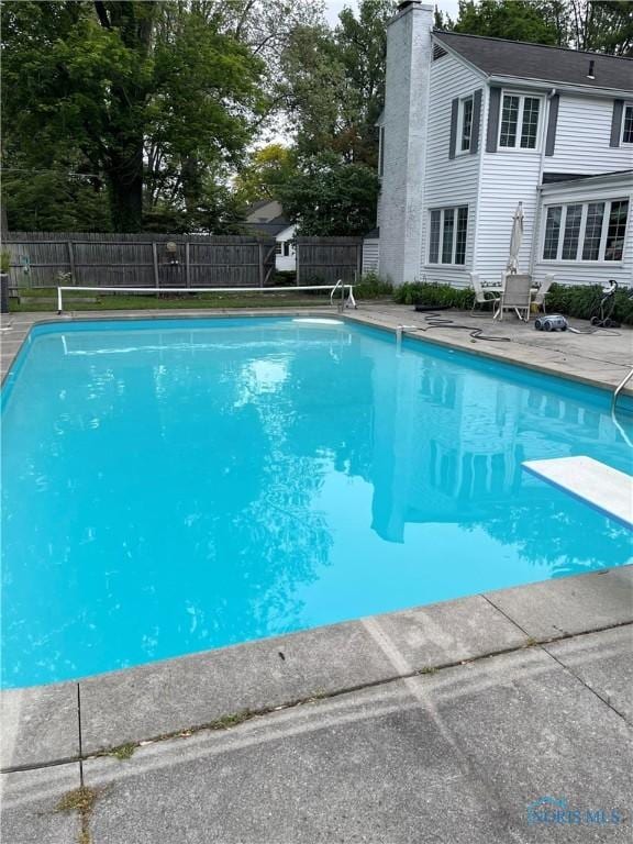 849 Wallace Ave, Bowling Green, OH 43402 - view of swimming pool featuring a diving board and a patio