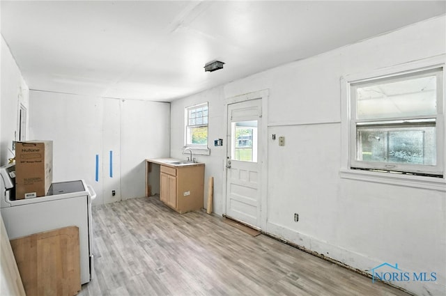 709 W Jackson St, Paulding, OH 45879 - washroom featuring a sink and light wood-style flooring