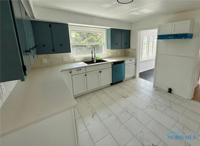 335 E N St, Mcclure, OH 43534 - kitchen featuring dishwasher, light marble finish flooring, light countertops, and decorative backsplash