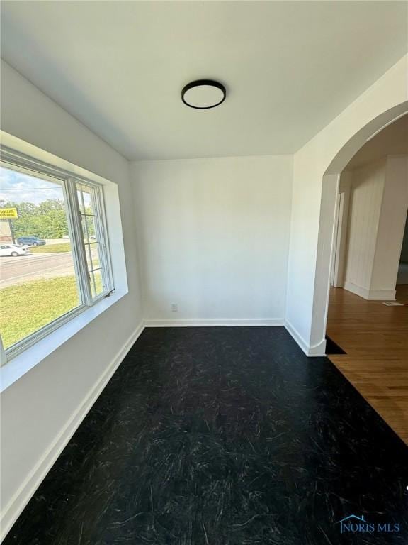 335 E N St, Mcclure, OH 43534 - unfurnished room with arched walkways and baseboards