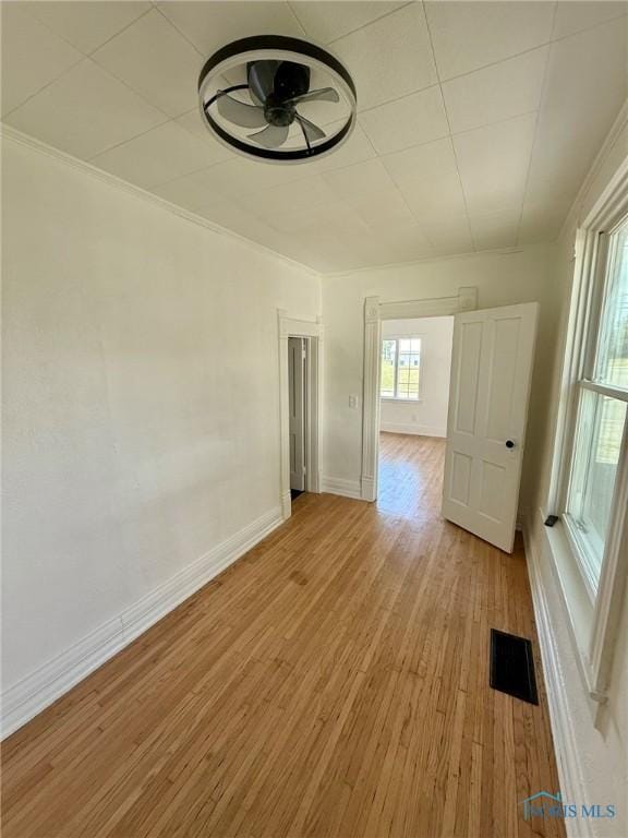 335 E N St, Mcclure, OH 43534 - empty room with light wood-style flooring, ceiling fan, and crown molding