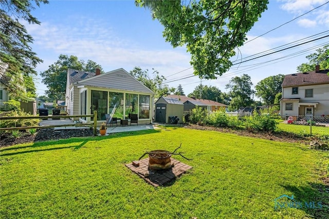 2958 Penrose Ave, Toledo, OH 43614 - view of yard with a fire pit, a shed, a sunroom, and a patio