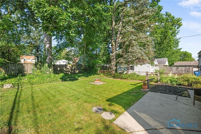 2958 Penrose Ave, Toledo, OH 43614 - fenced backyard featuring a patio and an outdoor fire pit