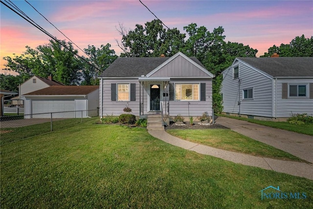 2958 Penrose Ave, Toledo, OH 43614 - bungalow-style home with board and batten siding and a detached garage