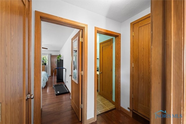 2958 Penrose Ave, Toledo, OH 43614 - hall with dark wood finished floors and a textured ceiling