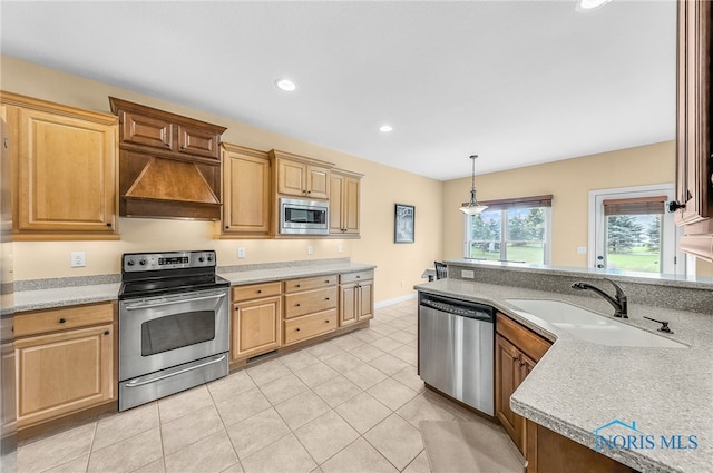 9701 Preakness Ln, Whitehouse, OH 43571 - kitchen with stainless steel appliances, premium range hood, light countertops, recessed lighting, and light tile patterned floors
