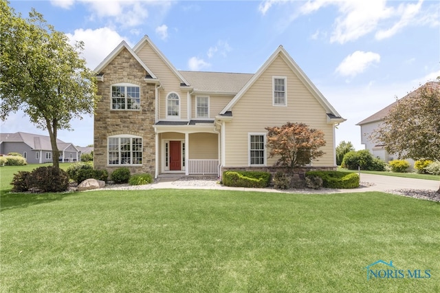 9701 Preakness Ln, Whitehouse, OH 43571 - traditional-style home featuring stone siding, covered porch, and a front yard