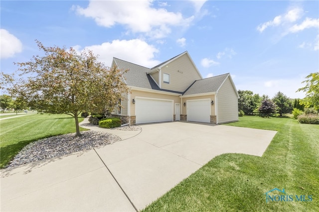 9701 Preakness Ln, Whitehouse, OH 43571 - view of side of home with an attached garage, a yard, stone siding, and driveway