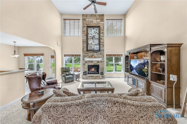9701 Preakness Ln, Whitehouse, OH 43571 - living area featuring carpet, ceiling fan, a fireplace, a towering ceiling, and arched walkways