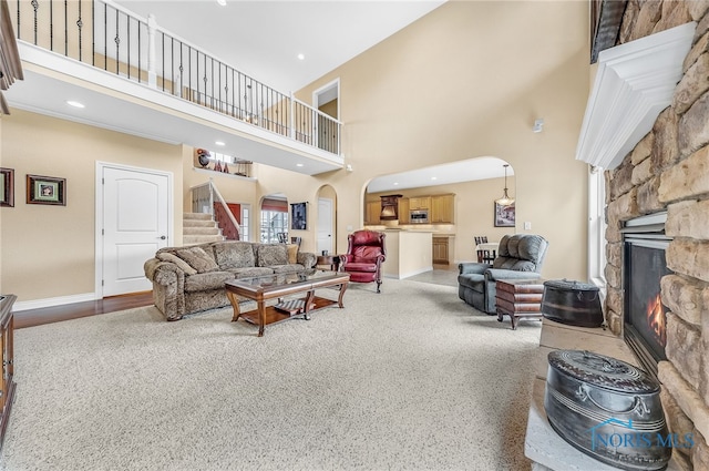 9701 Preakness Ln, Whitehouse, OH 43571 - living room with arched walkways, a fireplace, stairway, and a high ceiling