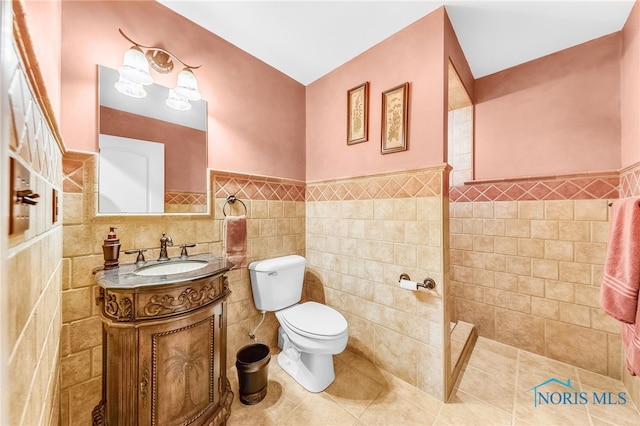 9701 Preakness Ln, Whitehouse, OH 43571 - full bathroom featuring tile walls, vanity, a wainscoted wall, tile patterned floors, and walk in shower