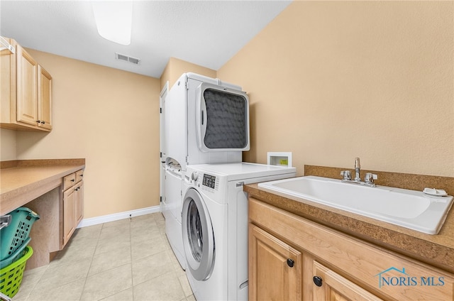 9701 Preakness Ln, Whitehouse, OH 43571 - laundry area featuring cabinet space, stacked washing machine and dryer, and light tile patterned floors