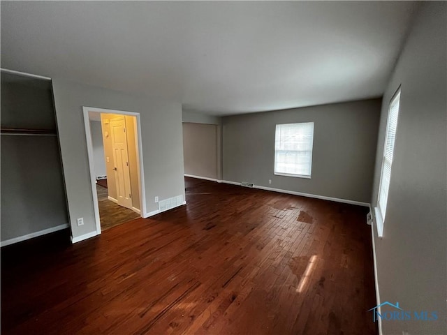 3217 Glanzman Rd Unit 14, Toledo, OH 43614 - unfurnished bedroom featuring multiple windows and dark wood-style floors