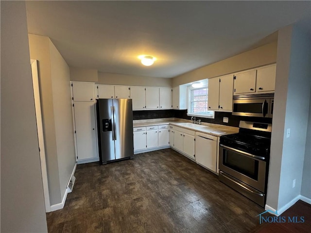 3217 Glanzman Rd Unit 14, Toledo, OH 43614 - kitchen with appliances with stainless steel finishes, white cabinets, light countertops, and dark wood-style floors