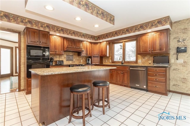 5303 Spring Crk, Sylvania, OH 43560 - kitchen featuring black appliances, a breakfast bar, decorative backsplash, a kitchen island, and recessed lighting