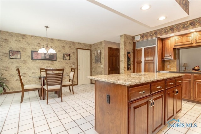5303 Spring Crk, Sylvania, OH 43560 - kitchen with wallpapered walls, a chandelier, paneled refrigerator, light tile patterned flooring, and a kitchen island