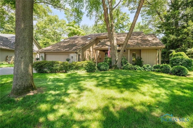 7118 Jamesford Dr, Toledo, OH 43617 - view of front of home with a front lawn and an attached garage