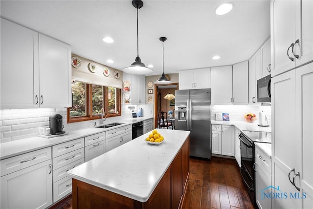 7118 Jamesford Dr, Toledo, OH 43617 - kitchen with black appliances, a center island, tasteful backsplash, white cabinets, and recessed lighting