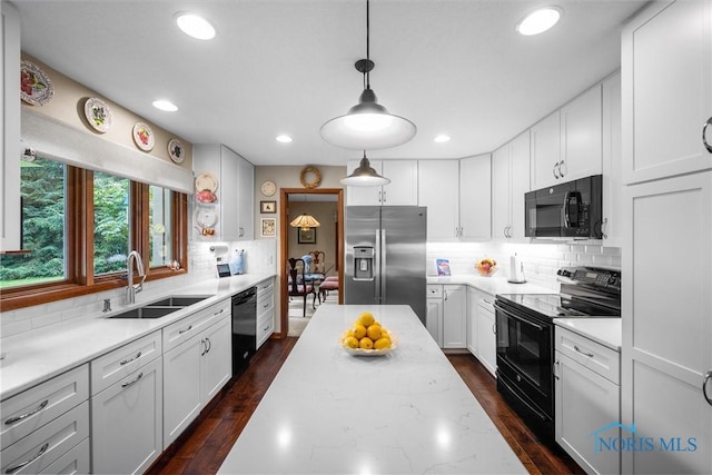 7118 Jamesford Dr, Toledo, OH 43617 - kitchen with black appliances, decorative backsplash, recessed lighting, and white cabinets