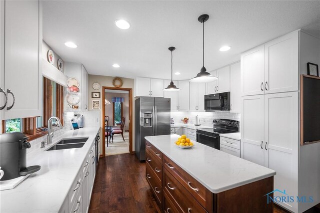 7118 Jamesford Dr, Toledo, OH 43617 - kitchen featuring black appliances, dark wood finished floors, white cabinetry, decorative backsplash, and recessed lighting