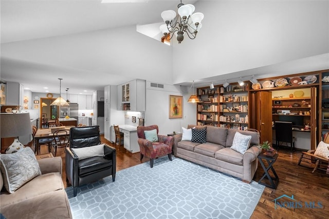 7118 Jamesford Dr, Toledo, OH 43617 - living room with a chandelier, wood finished floors, and high vaulted ceiling