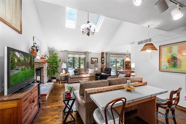 7118 Jamesford Dr, Toledo, OH 43617 - living room featuring high vaulted ceiling, a skylight, dark wood-type flooring, a brick fireplace, and a chandelier