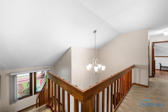 7118 Jamesford Dr, Toledo, OH 43617 - hallway featuring an upstairs landing, lofted ceiling, a chandelier, and light colored carpet