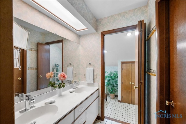 7118 Jamesford Dr, Toledo, OH 43617 - bathroom featuring double vanity and wallpapered walls