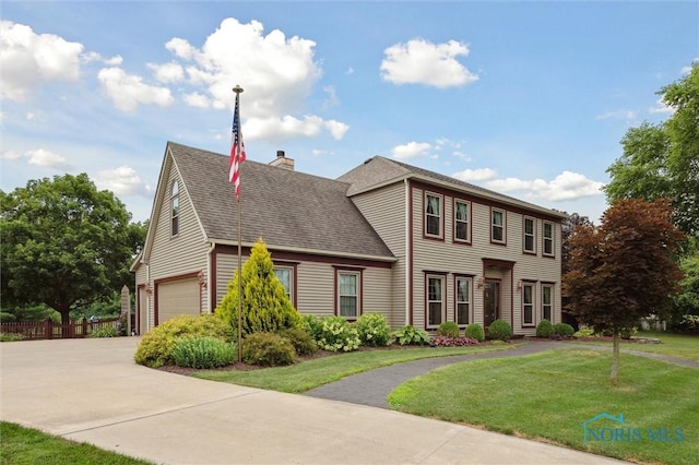 706 Grandview Ct, Elmore, OH 43416 - view of front of home featuring a chimney, a shingled roof, concrete driveway, and a garage