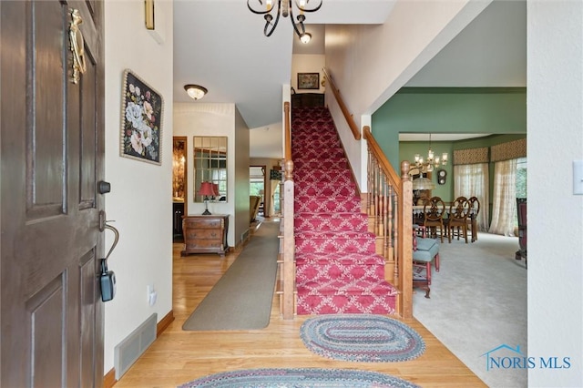 706 Grandview Ct, Elmore, OH 43416 - entryway featuring a chandelier, stairway, and wood finished floors