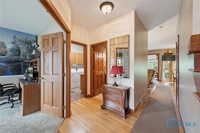 706 Grandview Ct, Elmore, OH 43416 - foyer with separate washer and dryer, light wood-type flooring, and vaulted ceiling