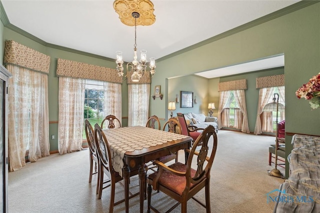 706 Grandview Ct, Elmore, OH 43416 - carpeted dining space with a chandelier, crown molding, and healthy amount of natural light