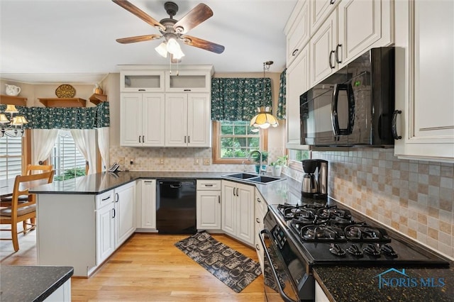 706 Grandview Ct, Elmore, OH 43416 - kitchen with black appliances, a peninsula, light wood finished floors, ceiling fan, and decorative backsplash