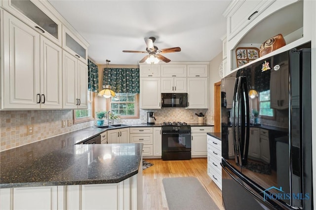 706 Grandview Ct, Elmore, OH 43416 - kitchen with black appliances, a ceiling fan, white cabinetry, and tasteful backsplash