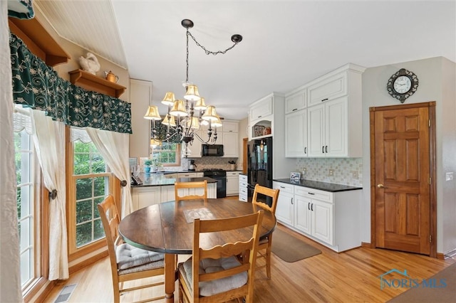 706 Grandview Ct, Elmore, OH 43416 - dining room with a chandelier and light wood finished floors