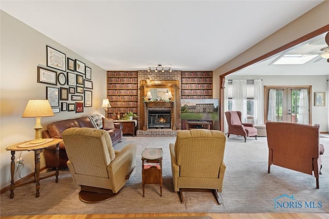 706 Grandview Ct, Elmore, OH 43416 - living room with a skylight, a fireplace, wood finished floors, and built in shelves
